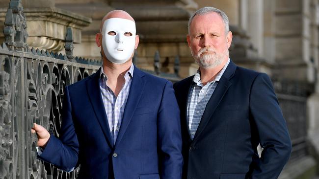 Masked brother “A”, left, and former NT Attorney-General John Elferink, right, are seeking to empower child abuse victims through the Sabre Foundation. Picture: AAP/Sam Wundke.