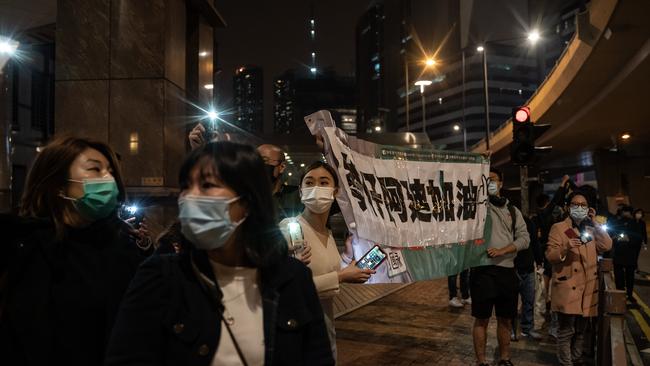 Supporters hold up banners following a bail hearing for 47 Hong Kong opposition activists charged with violating the city's national security law. Picture: Anthony Kwan/Getty Images