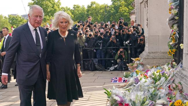 King Charles III and Britain's Camilla, Queen Consort view floral tributes at Buckingham Palace, a day after Queen Elizabeth II died at the age of 96. Picture: Yui Mok / POOL / AFP