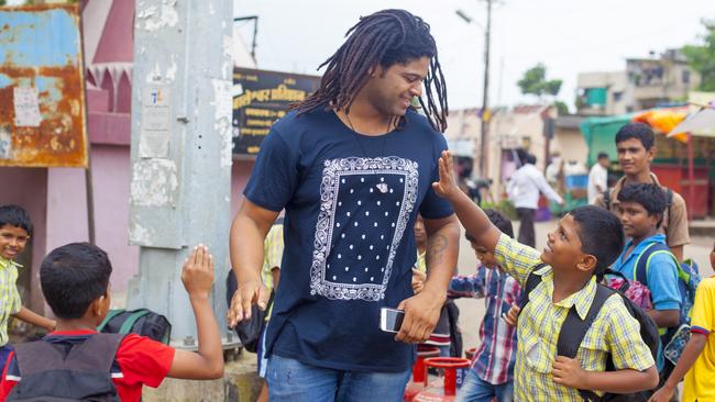 SUNDAY TELEGRAPH SPECIAL. MUST NOT BE PUBLISHED WITHOUT TALKING WITH JEFF DARMANIN, SUNDAY TELEGRAPH PIC ED. 14 July 2016 - Pune - INDIA. Jamal Idris with schools kid on way to school on the streets of Balewadi village at Pune. (Subhash Sharma for the Sunday Telegraph)