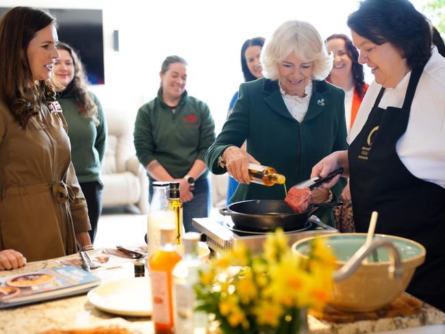 Queen Camilla uses the farm’s Broighter Gold rapeseed oil during a demonstration with chef Paula McIntyre and locals. Picture: AFP