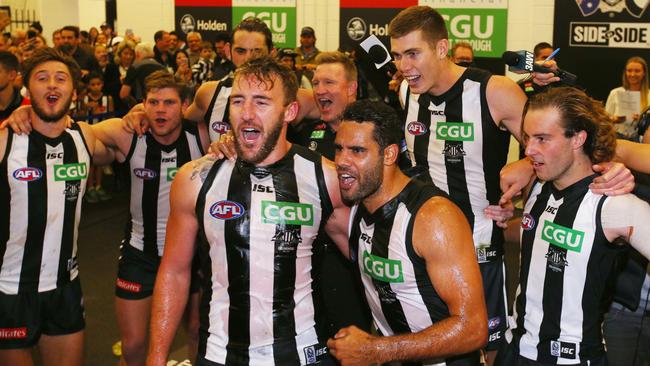 Lynden Dunn and Daniel Wells celebrate their first win as Magpies.