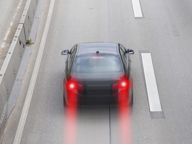 Dangerous situation on highway - a driver is braking hardly and tries to avoid a collision just before the traffic jam. High-angle view, motion blur. All identifiable logos and number plates have been removed in order to create generic looks.