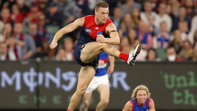 MELBOURNE, AUSTRALIA - MARCH 16: Tom McDonald of the Demons kicks the ball during the 2022 AFL Round 01 match between the Melbourne Demons and the Western Bulldogs at the Melbourne Cricket Ground on March 16, 2022 In Melbourne, Australia. (Photo by Michael Willson/AFL Photos via Getty Images)