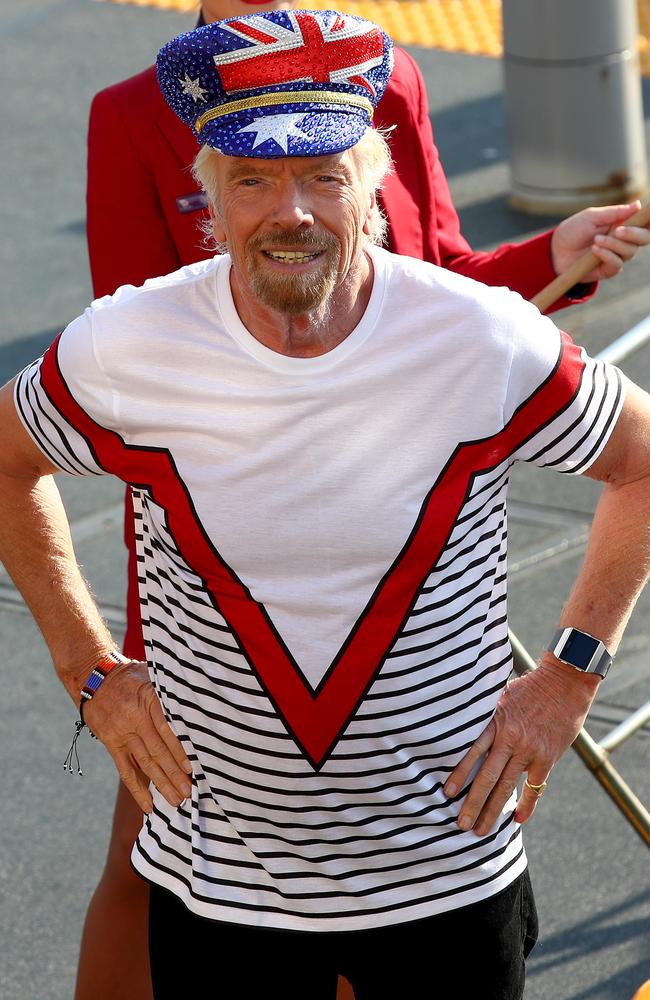 Sir Richard Branson greets commuters to announce Virgin Voyages and Virgin Australia will offer flight and cruise packages for Aussies wanting to cruise the Caribbean. Picture: Toby Zerna