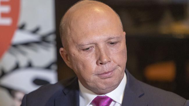 ‘An accident’. Peter Dutton’s office has responded to claims a volunteer in his campaign was seen holding Clive Palmer’s how-to-vote cards. Picture: AAP 