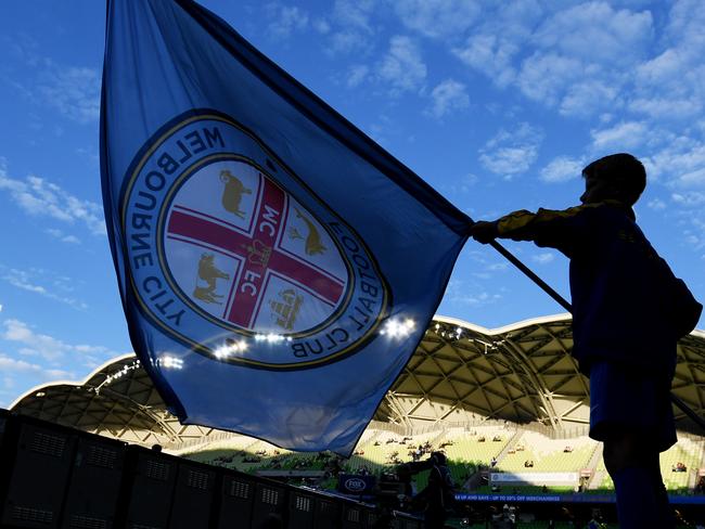 A supporter waves a Melbourne City flag before the Round 22 A-League match between Melbourne City and Melbourne Victory at AAMI Park in Melbourne, Friday, March 2, 2018. (AAP Image/Tracey Nearmy) NO ARCHIVING, EDITORIAL USE ONLY