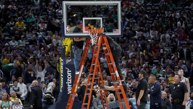 How many people does it take to fix a hoop? Photo: Matthew Stockman/Getty Images/AFP