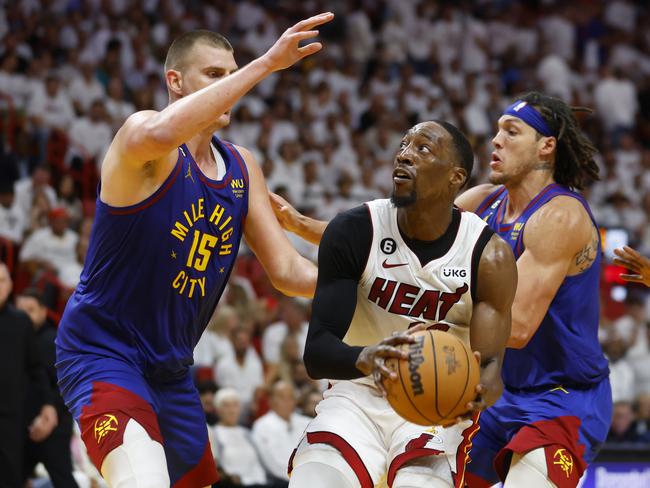 MIAMI, FLORIDA - JUNE 07: Bam Adebayo #13 of the Miami Heat drives to the basket against Nikola Jokic #15 of the Denver Nuggets during the fourth quarter in Game Three of the 2023 NBA Finals at Kaseya Center on June 07, 2023 in Miami, Florida. NOTE TO USER: User expressly acknowledges and agrees that, by downloading and or using this photograph, User is consenting to the terms and conditions of the Getty Images License Agreement. (Photo by Mike Ehrmann/Getty Images)