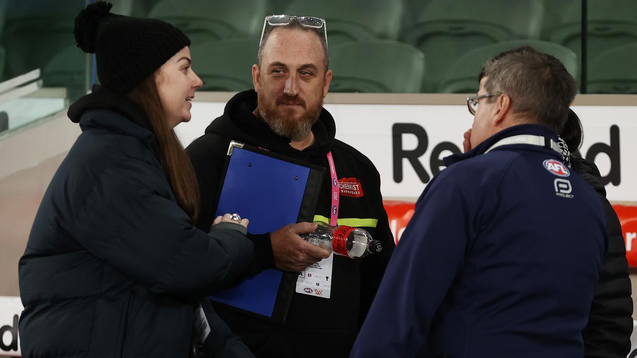 Club interchange stewards talk to AFL officials following North Melbourne’s loss to Sydney at Marvel Stadium. Picture: Michael Klein