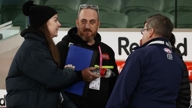 Club interchange stewards talk to AFL officials following North Melbourne’s loss to Sydney at Marvel Stadium. Picture: Michael Klein