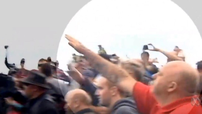 A man throws his arm up in a Nazi salute at St Kilda. Picture: ABC News