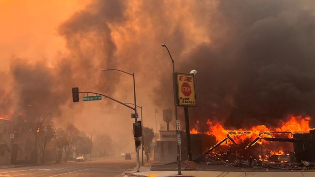 Flames from the wind-driven Eaton Fire engulf a house in Altadena, California. Picture: AFP