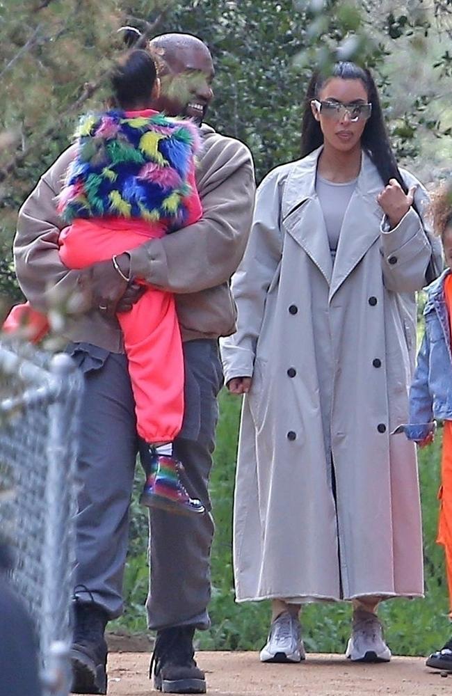 ‘Confirmed last night’. Kanye West, pictured holding daughter North West with Kim Kardashian, is Coachella-bound. Picture: Backgrid