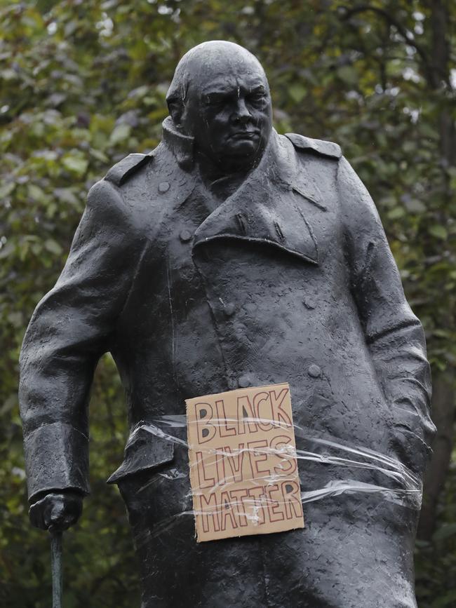 A placard is put on the Winston Churchill statue during the Black Lives Matter protest in London. Picture: