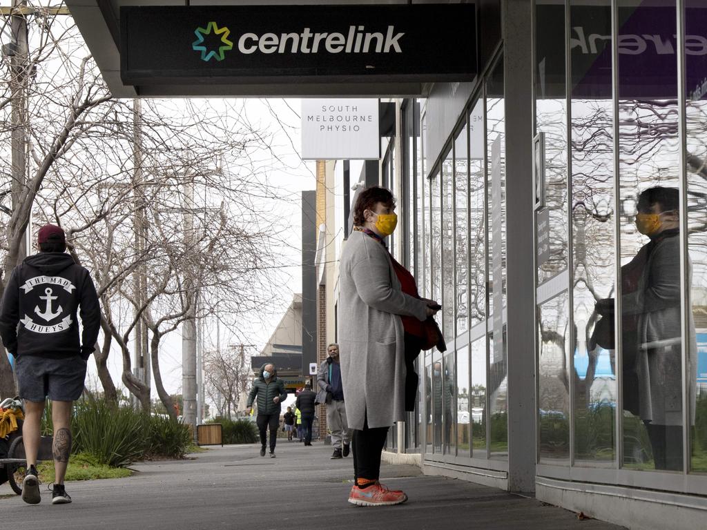 A woman waits outside Centrelink in South Melbourne on Monday during stage 4 COVID-19 lockdowns across Melbourne. Picture: David Geraghty