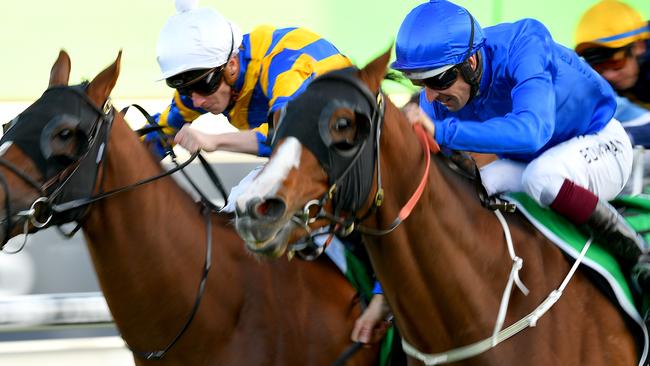 Hugh Bowman rides Phaistos (right) to victory at Royal Randwick. Picture: AAP