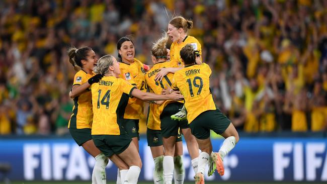 Cortnee Vine (top) celebrates with teammates after her matchwinning penalty. Picture: Getty