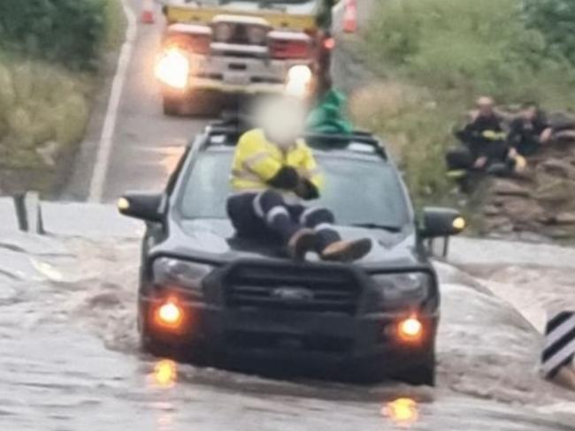 A 48 year old man took refuge on his car bonnet after being inundated by floodwaters outside Nebo. Photo: QFES