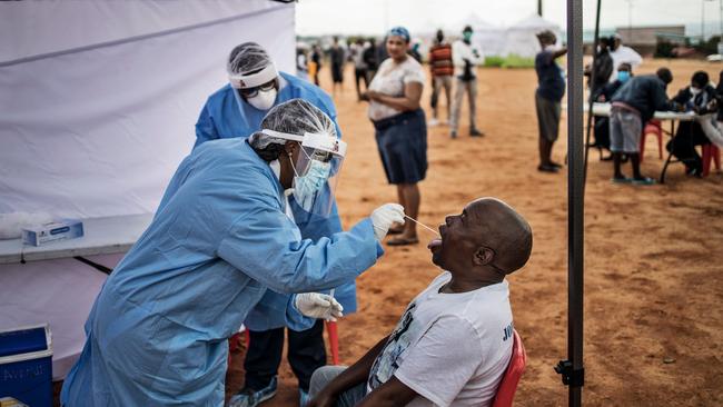 A resident of the sprawling township of Alexandra in Johannesburg receives a swab test for COVID-19. Picture: AFP