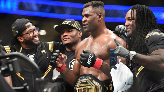 UFC 270 heavyweight world champion Cameroon's Francis Ngannou (C) celebrates victory over France's Ciryl Gane after their fight for the heavyweight title at the Honda Center in Anaheim, California on January 22, 2022. (Photo by Frederic J. BROWN / AFP)