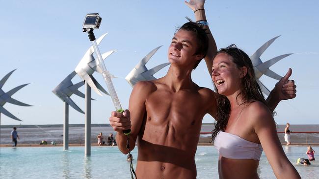 French travellers Remi Delavaud and Melody Frioux take GoPro selfies at the Cairns Esplanade lagoon. PICTURE: STEWART MCLEAN