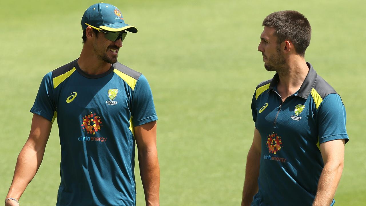 Mitchell Starc and Mitchell Marsh chat while warming up during a training session at the WACA.