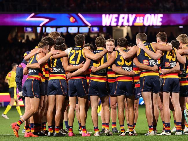 ADELAIDE, AUSTRALIA - JUNE 15: Crows players huddle to listen to captain Jordan Dawson during the 2024 AFL Round 14 match between the Adelaide Crows and the Sydney Swans at Adelaide Oval on June 15, 2024 in Adelaide, Australia. (Photo by Sarah Reed/AFL Photos via Getty Images)