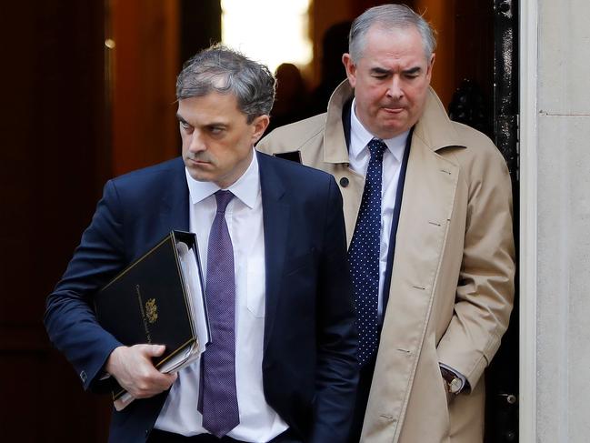 Britain's Conservative Party Chief Whip Julian Smith (L) and Britain's Attorney General Geoffrey Cox leave after attending the weekly meeting of the cabinet at 10 Downing Street in London on November 13, 2018. - Prime Minister Theresa May today faced her divided ministers as negotiators scrambled to secure a divorce agreement with the European Union and anxiety mounted over the risk of a no-deal Brexit. (Photo by Tolga AKMEN / AFP)