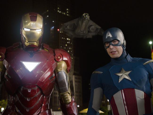 This film image released by Disney shows, Iron Man, portrayed by Robert Downey Jr., left, and Captain America, portrayed by Chris Evans, in a scene from 