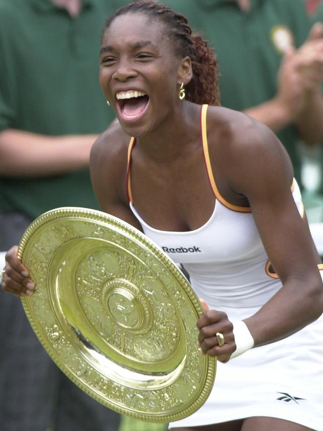 Williams laughs as she holds the trophy after beating Lindsay Davenport.