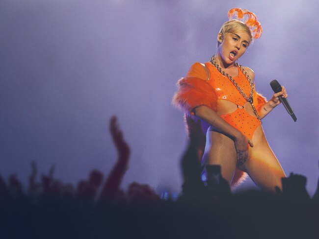 Concert garb: Miley on stage at Brisbane Entertainment Centre.