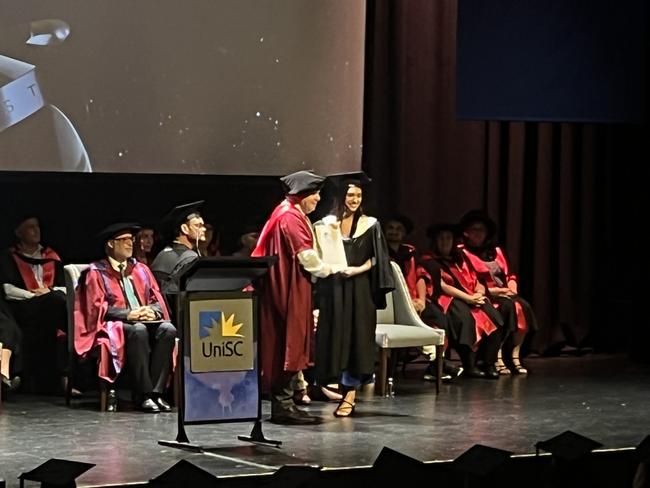 Graduates from the University of the Sunshine Coast's Fraser Coast campus celebrating at the Brolga Theatre.