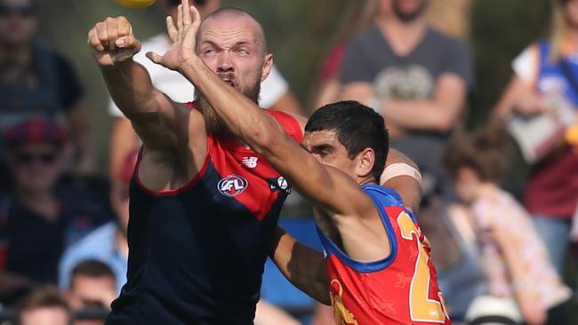 Melbourne v Brisbane Lions at Casey Fields, Cranbourne. 09/03/2019 . Melbourne's Max Gawn punches the ball away from Brisbane Lions' Charlie Cameron . Pic: Michael Klein