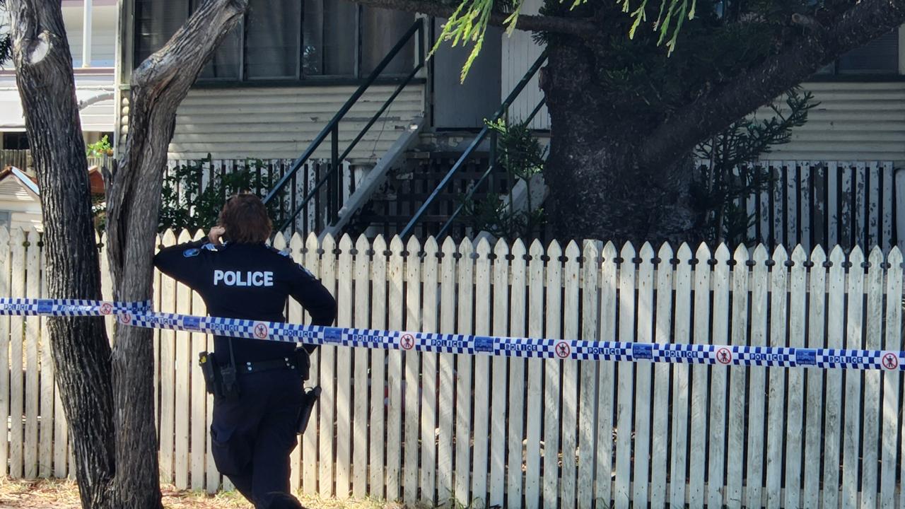 A police officer stands in front of the Elphinstone Street house after the fire on Thursday, December 29, 2022.