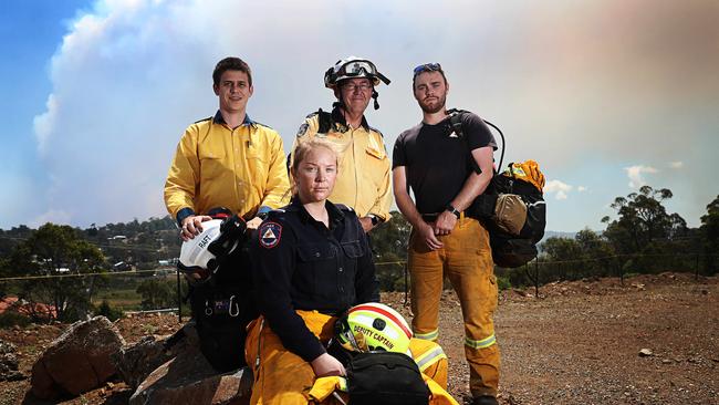 (L-R) Tim Colefax from NSW Rural Fire Service, Jess Playford ACT Rural Fire Service, Colin Fitzgibbon, NSW Rural Fire Service and Daniel Bowran from ACT Rural Fire Service awaiting deployment as a remote are firefighting team at the community centre in Miena. Picture: LUKE BOWDEN