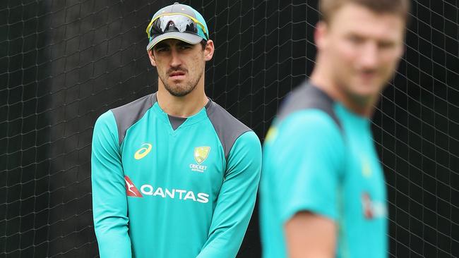 Mitchell Starc looks on as Jackson Bird trains in Melbourne.