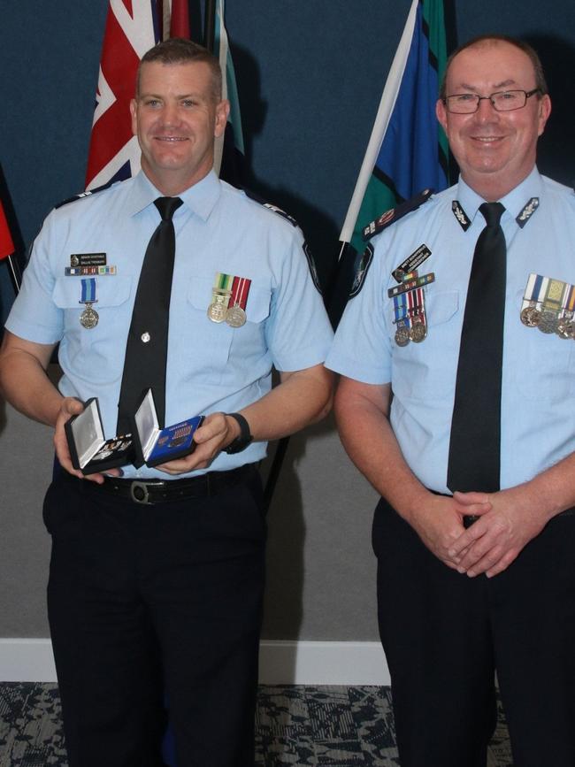 Senior Constable Dallas Trembath from highway patrol receiving a national Police Service Medal and National Medal. Picture: QPS.