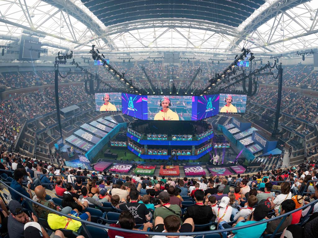 (FILES) In this file photo taken on July 27, 2019 Richard Tyler Blevins (on screen), aka Ninja, speaks to the crowd at the start of the 2019 Fortnite World Cup Finals - Round Two  at Arthur Ashe Stadium, in New York City. - Fortnite rejoiced on October 15, 2019 as a new chapter began, freeing them from staring at a black hole that marked the end of the last one. "Drop into a New World Fortnite Chapter 2 is available now. Share your #FirstDrop!," Fortnite tweeted.On Sunday, an asteroid blew up the Fortnite virtual world, where users must search for weapons and other resources while eliminating other players -- all while trying to stay alive. (Photo by Johannes EISELE / AFP)