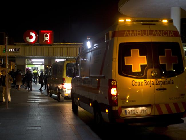 Ambulances wait outside a train station after a train hit the buffers in Alcala de Henares, central Spain. Picture: AP