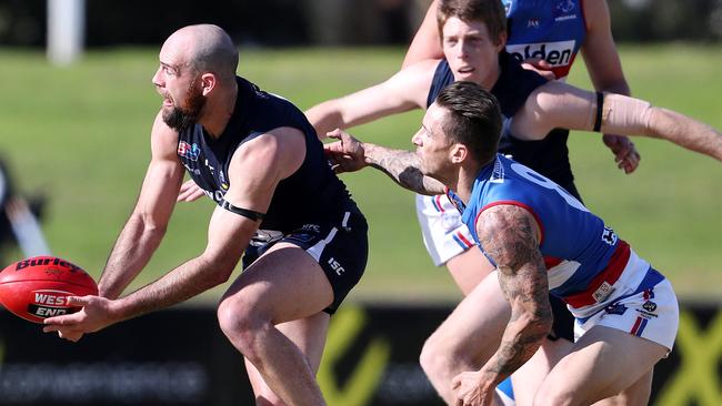 Central District’s James Boyd attempts to tackle South Adelaide’s Matthew Broadbent at Elizabeth Oval. Picture: Sarah Reed