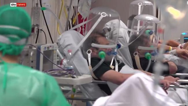 Italian patients being treated for coronavirus are seen with their heads zipped into oxygen helmets at a hospital in Milan. Picture: SkyNews