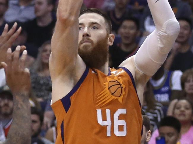 Phoenix Suns center Aron Baynes (46) shoots a 3-pointer over Portland Trail Blazers guard Damian Lillard (0) during the second half of an NBA basketball game Friday, March 6, 2020, in Phoenix. The Suns won 127-117. (AP Photo/Ross D. Franklin)