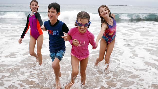 Coogee locals Grace, Max, Lily and Ava Dean brave the cool weather at the beach on Saturday. Picture: Sam Ruttyn