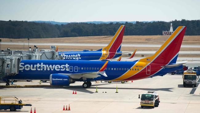 (FILES) In this file photo taken on March 13, 2019 a Boeing 737 Max 8 flown by Southwest Airlines sits at the gate at Baltimore Washington International Airport  near Baltimore, Maryland. - The crisis at Boeing over the grounded 737 MAX aircraft weighed on US durable goods orders in May, helping push the closely watched economic indicator to its lowest level in 16 months, government data showed on June 26, 2019. Sales of big-ticket US-made durable goods fell for the second straight month, exacerbating a general slowdown in manufacturing orders.Outside the volatile area of transportation, sales were a little stronger than expected but economists noted a softening trend. (Photo by Jim WATSON / AFP)