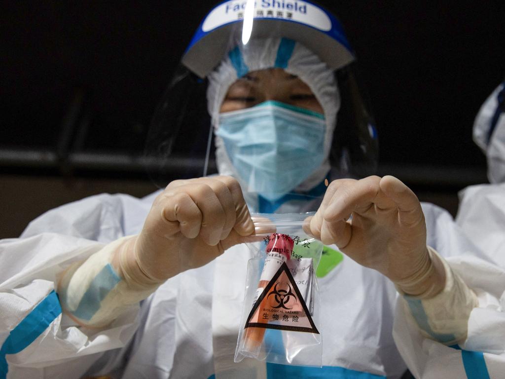 A medical worker collecting a sample of a nucleic acid test for Covid-19 in Nanjing, China. Picture: AFP