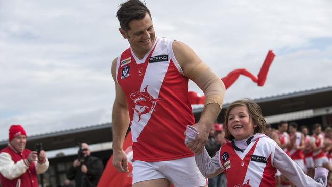 Guy Stringer walks onto the ground with his daughter Olivia before his 400th match. Picture: Christopher Chan.