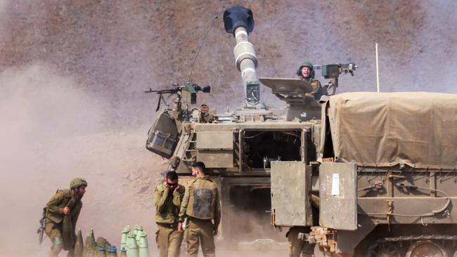 An Israeli army self-propelled howitzer fires rounds near the border with Gaza in southern Israel.