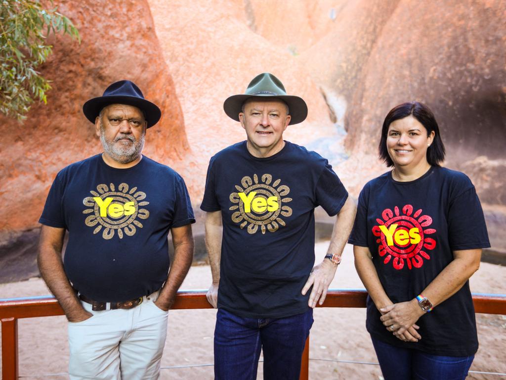 Australian Prime Minister Anthony Albanese, centre, wears his Akubra hat on the Yes campaign trail at the base of Uluru with Indigenous rights activist Noel Pearson at left and Northern Territory Chief Minister Natasha Fyles on October 11. Picture: Stringer/AFP