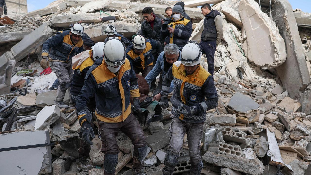 Members of the Syrian civil defence, known as the White Helmets, transport a casualty from the rubble of buildings in the village of Azmarin in Syria's rebel-held northwestern Idlib province. Picture: Omar Haj Kadour/AFP